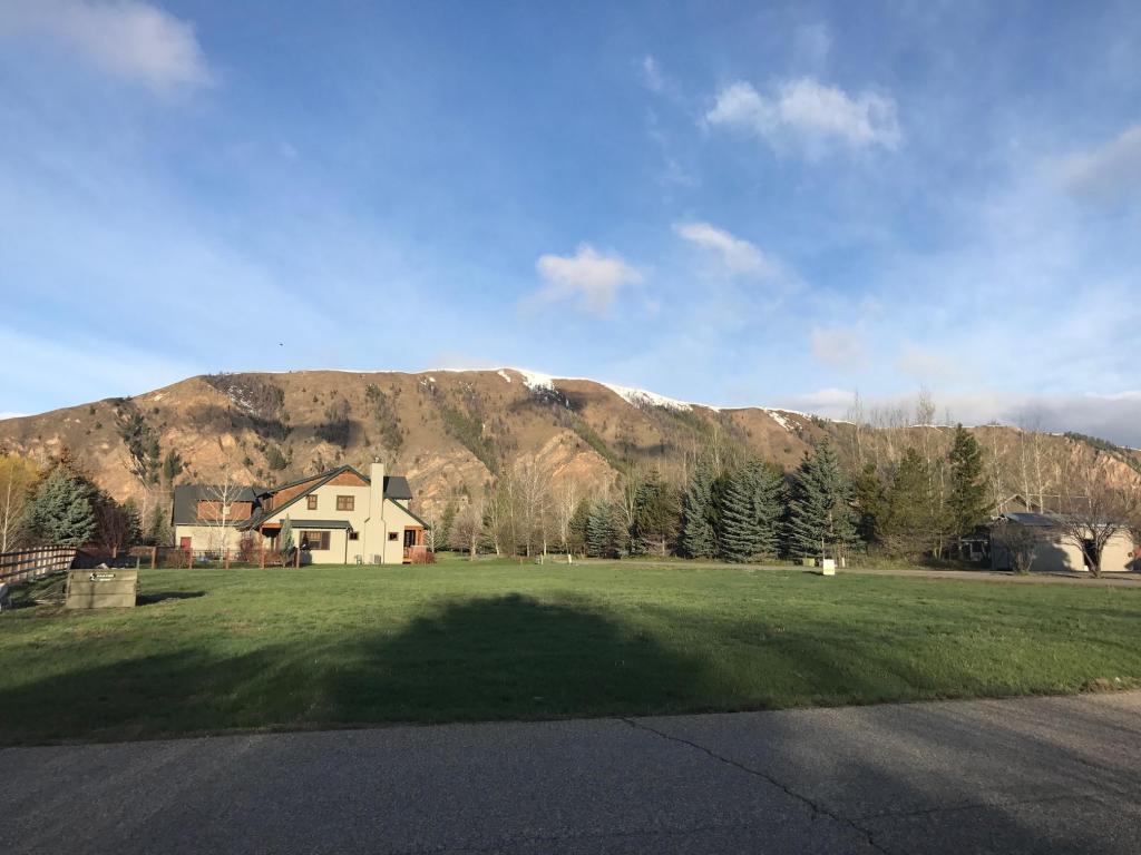 empty lot for sale with mountains and green grass
